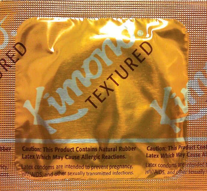 Kimono Type E textured latex condom packet with caution warnings on packaging.