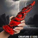 Creature Cock Kraken Spawn Tentacle Silicone Dildo held in hand with dramatic tentacle design and red color.