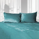 Liberator Fascinator Liquid Velvet King Sheets Teal featuring luxurious teal velvet pillows on a plush surface.