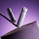 ZALO Lia Suction Massager Lavender Purple resting beside a travel pouch, showcasing its elegant design and discreet portability.