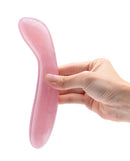 Le Wand Crystal G-Wand Stimulator Rose Quartz in hand, showcasing its smooth rose quartz design for G-spot pleasure.
