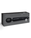 Le Wand Die Cast Plug-In Massager Black showcased in packaging with sleek design and powerful features.