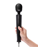 Le Wand Die Cast Plug-In Massager Black held in hand, showcasing its sleek design and powerful features.