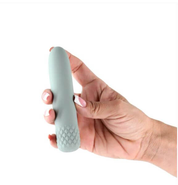 Lust-N-Dreams Mambo Mini Vibrator in green held in hand showcasing its sleek design and body-safe silicone texture.