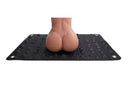 Person kneeling on the Edge Spiked Punishment Mat Black showcasing pressure points and pyramid spikes.