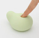 Close-up of Tenga Iroha Midori Massager being pressed, highlighting its soft-touch texture and ergonomic design.