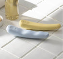 Tenga iroha TSUKI MINAMO silicone massagers in blue and yellow on a tiled surface.