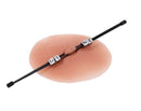 Edge MINE Pinching Rods Black positioned on a soft silicone surface, showcasing its sleek design for sensory play.