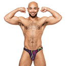 Muscular man flexing while wearing the Galactic Print Bong Thong from Male Power Lingerie, showcasing its vibrant colors.