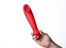 Destiny Red Sucking Clitoral Stimulator held in hand, showcasing its sleek design and suction feature.