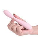 Love Notes Eclipse G-Spot Vibrator Pink held in hand, showcasing its sleek design and compact silhouette for pleasure.