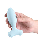 Love Notes Velour Vibrating Butt Plug Blue held in hand, showcasing the sleek design in soft silicone.