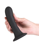Love Notes Shadow Silicone Suction Cup Dildo Black held in hand, showcasing its sleek design and suction cup base.