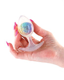 Cosmic Glams Medium Butt Plug Rainbow held in hand, featuring a sparkling internal glass marble.
