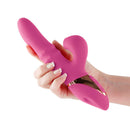 Hand holding the Inya Enamour pink silicone rabbit vibrator with air pulse clitoral stimulator.