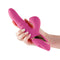 Hand holding the Inya Enamour pink silicone rabbit vibrator with air pulse clitoral stimulator.