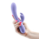 Inya Love Bunny Rechargeable Silicone Rabbit Vibrator Purple held in a hand showcasing its elegant design and color.