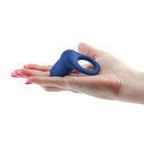 Inya Regal Rechargeable Silicone Cock Ring Blue held in a hand, showcasing its ergonomic design.