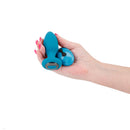 Inya Alpine Rechargeable Anal Plug with Remote Control Teal held in a hand, showcasing its ergonomic design and remote control.