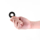Person holding the Renegade Fireman Ring Small Black in hand, showcasing its design and flexibility.