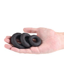 Renegade Players Silicone Cock Ring Set Black shown in hand, featuring three stretchy rings of different sizes for comfort.