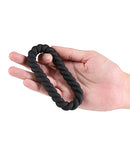 Renegade Helix Silicone Cock Ring Black held in hand, showing its comfortable design and sleek black finish.