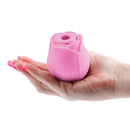 Inya The Rose Rechargeable Suction Clitoral Stimulator Pink held in a hand, showcasing its elegant rose design.