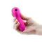 Revel Vera Rechargeable Silicone Clitoral Stimulator in pink held in hand, showcasing its sleek design and controls.