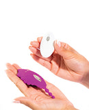 Natalie's Toy Box Shell Yeah Remote Panty Vibrator Purple held in hands with remote control.