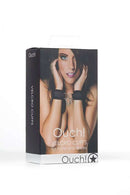 Ouch Velcro Cuffs Black packaging featuring model with cuffs for hands and ankles.