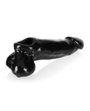 Oxballs Daddy Cocksheath Black on a reflective surface showcasing its realistic design and texture.