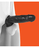 Oxballs Muscle Bandit Cocksheath Black displayed on a realistic model against a vibrant orange background.