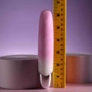 Playboy Bunnies on Parade pink silicone vibrator next to a ruler for size comparison.
