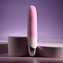 Playboy Bunnies on Parade pink rechargeable silicone vibrator on a purple background.