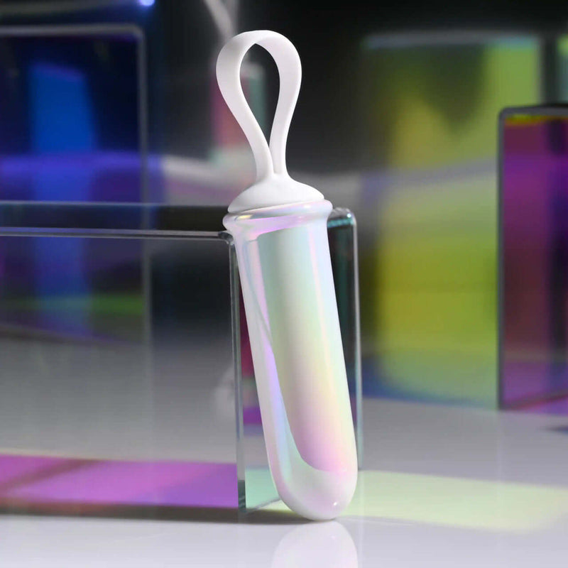 Playboy Orgasmic Fantasy Rechargeable Silicone Bullet in white and purple with iridescent glow for targeted vibrations.