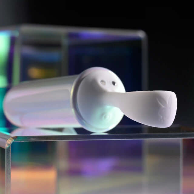 Playboy Orgasmic Fantasy Rechargeable Silicone Bullet in white, featuring a finger loop for easy navigation and multi-speed settings.