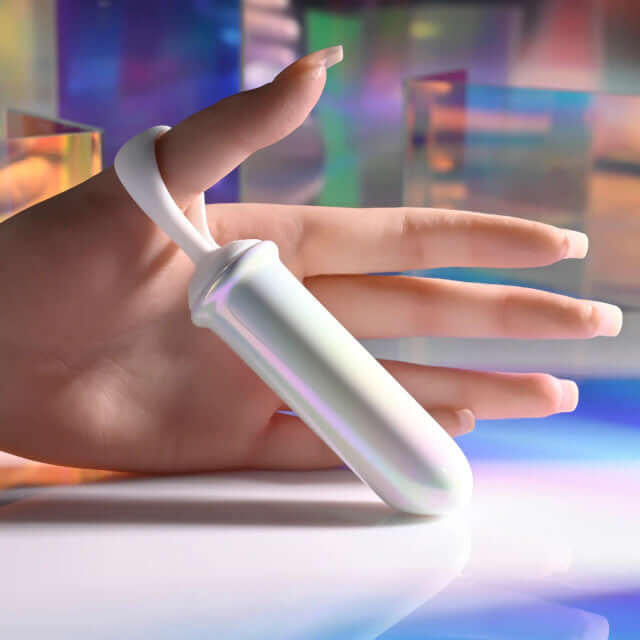 Playboy Orgasmic Fantasy rechargeable silicone bullet held in a hand, showcasing its iridescent finish and ergonomic design.