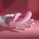 Playboy Rabbit Party Silicone Rabbit Vibrator Purple on a hand against a pink background with bunny head details.