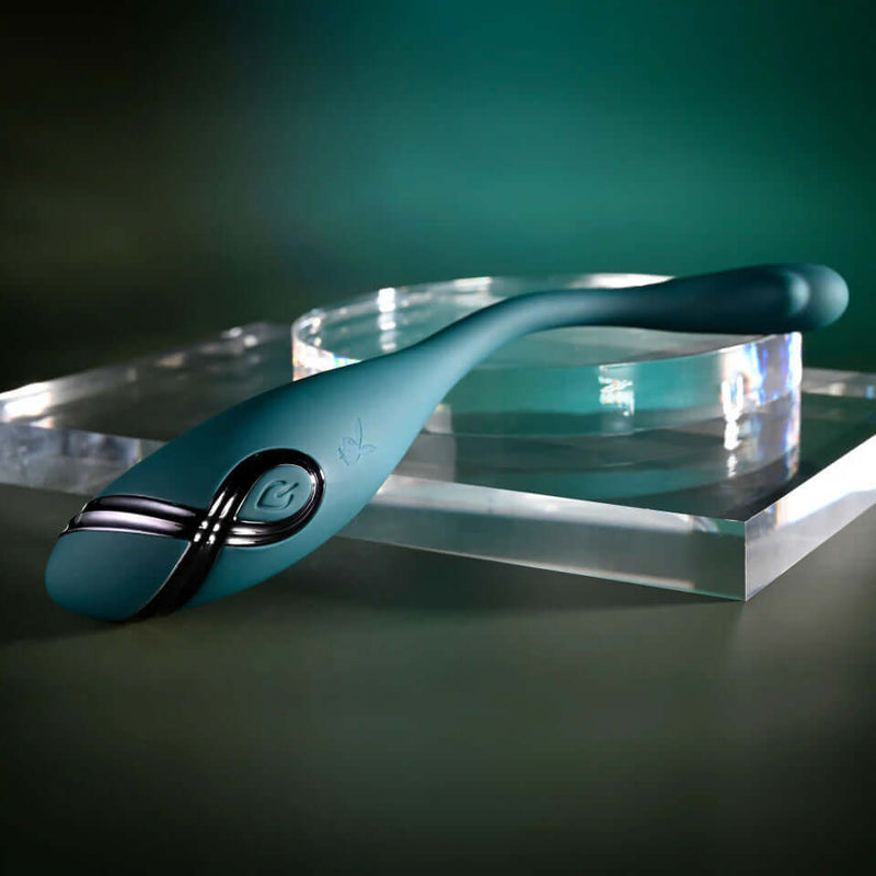Playboy Pin Point Perfection Bendable Precision Vibrator on display with sleek teal design and flexible shaft.