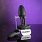 Playboy Rim Shot Rechargeable Silicone Anal Plug Black with remote on display against a purple background.