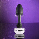 Playboy Rim Shot Rechargeable Silicone Anal Plug Black displayed on a shiny purple background.