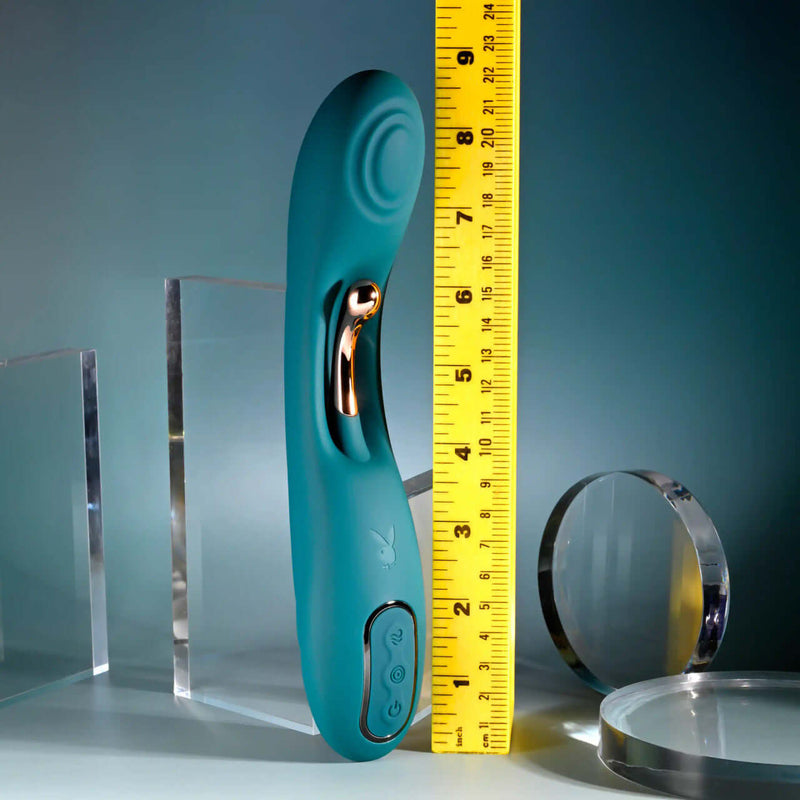 Playboy Aurelie Rechargeable Silicone G-Spot Vibrator in green with measuring tape for size reference.