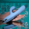 Playboy Up and Away Rechargeable Silicone Rabbit Vibrator in blue, with flexible clitoral stimulator, on reflective surface.