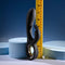 Black silicone dual vibrator with chrome ring, measuring ruler beside for size reference.