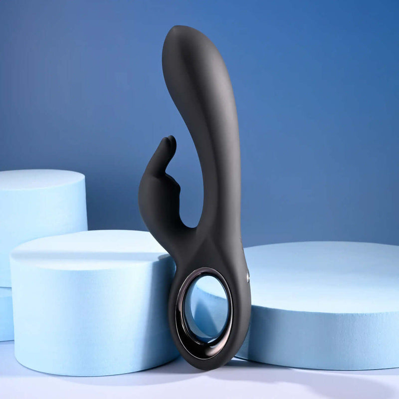 Playboy Late Night Bunny rechargeable dual vibrator in black, showcased on blue display foam.