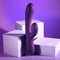 Playboy New Crush Rechargeable Silicone Dual Vibrator in purple positioned against white geometric shapes.