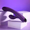 Playboy New Crush rechargeable silicone dual vibrator in purple against a soft purple backdrop.