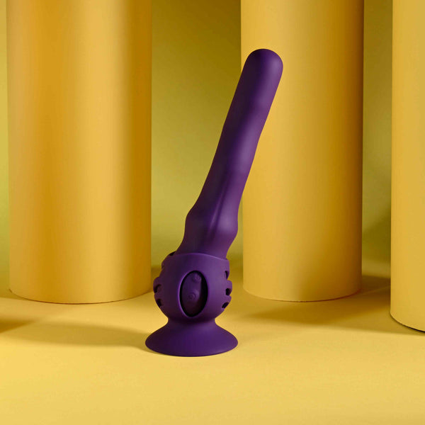 Playboy Wiggle It Rechargeable Wiggling Shaft Purple against a yellow backdrop, showcasing its unique design and color.