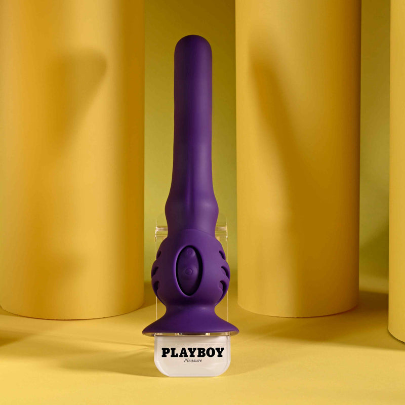 Playboy Wiggle It Rechargeable Wiggling Shaft Purple on display against a yellow background.