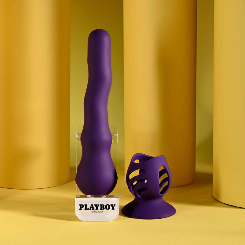 Playboy Wiggle It Rechargeable Wiggling Shaft Purple on display with modern design elements in the background.